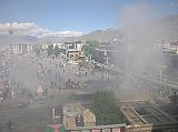 Tibet Lhasa 02 14 Jokhang Roof View to Barkhor Square and Potala Because it was the Dalai Lama�s birthday, the juniper leaves were burning especially heavy, sending tons of smoke to the Jokhang roof and on to the heavens. From the Jokhang's roof, we looked down at Barkhor Square and the Jowo Utra (Hair of the Buddha), a recently built stone enclosure with a willow tree and two 3m tall steles.